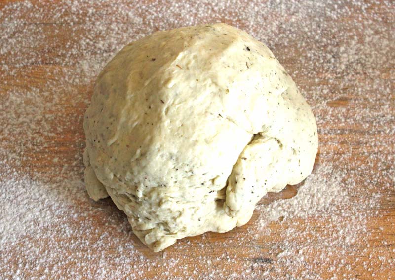 Dough ready to knead on board with flour