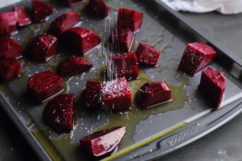 beets ready for roasting on the sheet pan with olive oil and salt