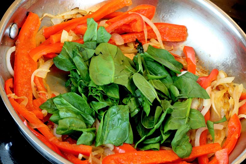 red pepper onion spinach in pan