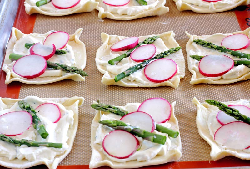 Lemon and Ginger infused cream cheese atop puff pastry and topped with Asparagus & Radish. My kids call them the healthy pop tarts, I call them party fab