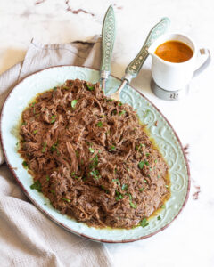 Succulent barbacoa made in your slow cooker or crockpot is the perfect meal to come home too. Savory, a little sweet and perfectly seasoned. #dinner #crockpot #slowcooker #beef