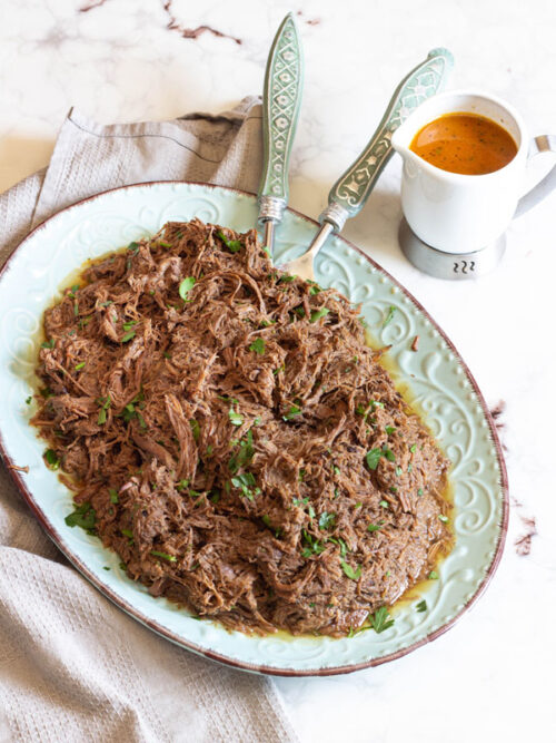 Succulent barbacoa made in your slow cooker or crockpot is the perfect meal to come home too. Savory, a little sweet and perfectly seasoned. #dinner #crockpot #slowcooker #beef